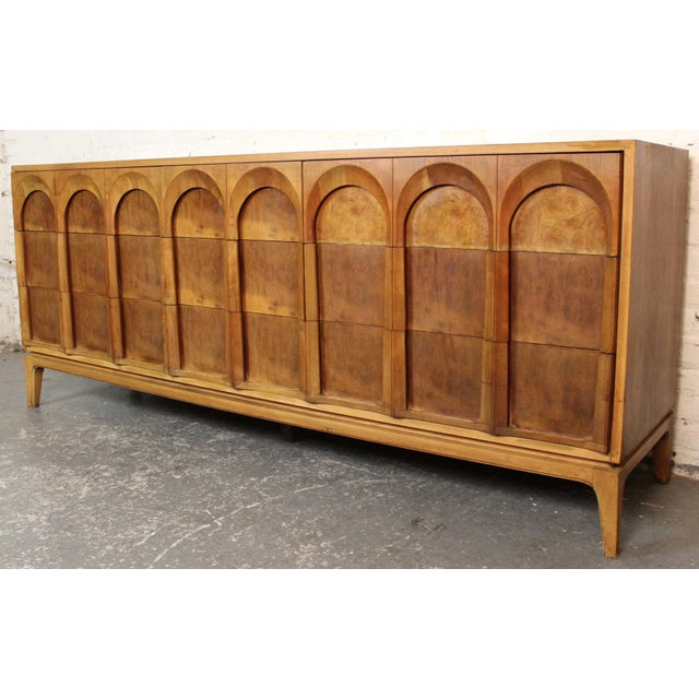 Sculptural mid-century lowboy dresser by Thomasville, featuring the iconic arched façade with richly figured burl inlays...