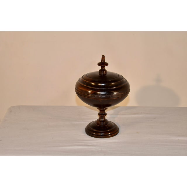 19th century hand turned fruitwood lidded treen box from England. The top has an applied hand turned finial over a turned...