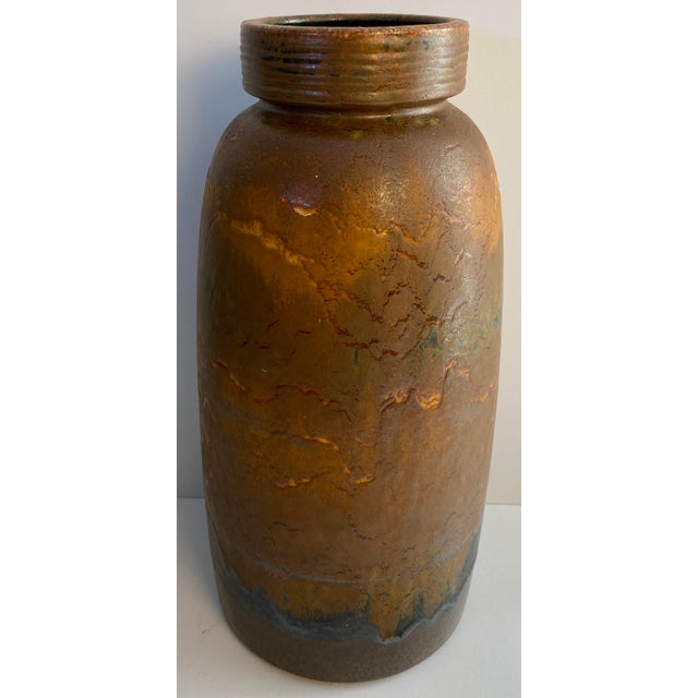 A striking Mid-Century Modern West German ceramic vase featuring a richly textured volcanic "Fat Lava" glaze in warm...