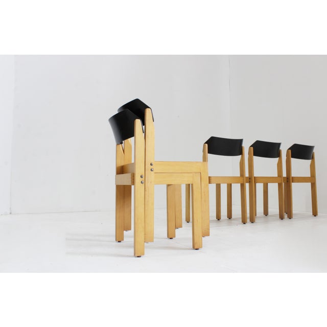 Vintage stackable mid century dining chairs made of wood with black lacquered backrest. Easily stackable. German...