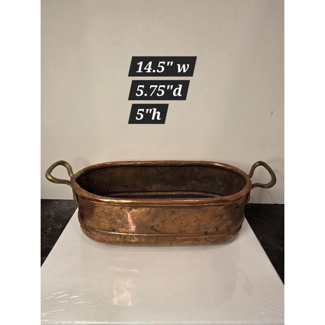 Great looking vintage copper and brass elongated pot ...great for a floral arrangement or collection of stone fruit,shells...