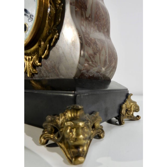 A stunning bronze cherub sits at the place of honor at the top of this French mantel clock. The body of the clock is made...