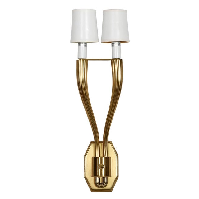 A sophisticated pair of Art Deco style gilt bronze wall sconces featuring elegant double-arm forms with sculptural, fluted...