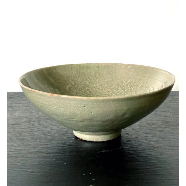 A Korean stoneware bowl from Goryeo dynasty circa 12th century. The conical form bowl with a small raised foot rim is...