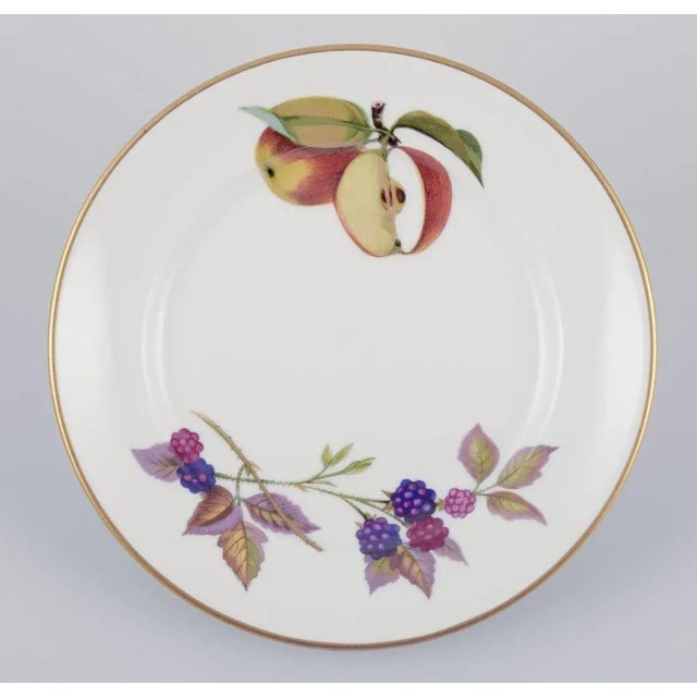 Royal Worcester, England. A set of nine Evesham porcelain plates decorated with fruit and gold trim. 1980s. In excellent...