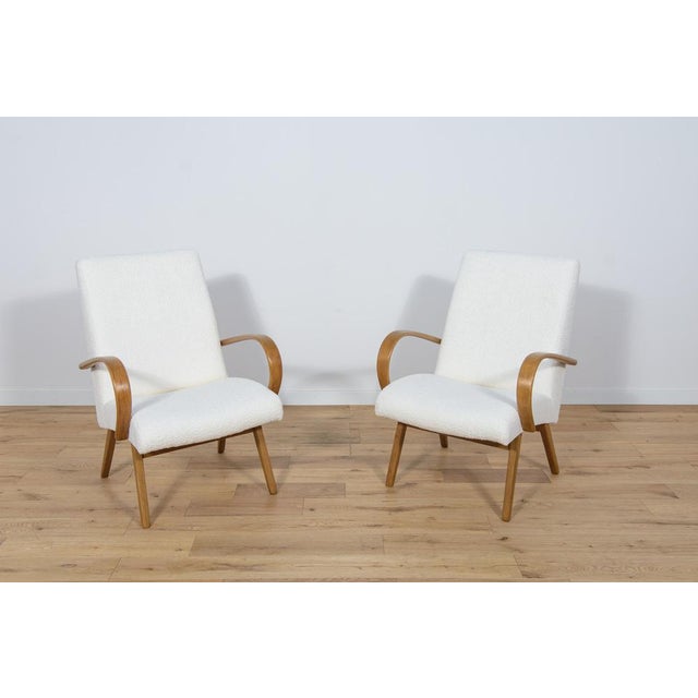 This pair of model 53 armchairs was manufactured by Ton in the 1950s to 1960s. They were designed by Jaroslav Smidek. The...