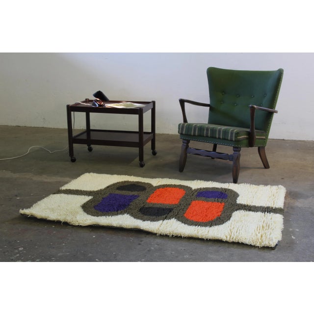 Rya rug by Ib Antoni in wool. Clean and fluffy. Tones of blue and brown cream white and red. Has a little sence of smoke...