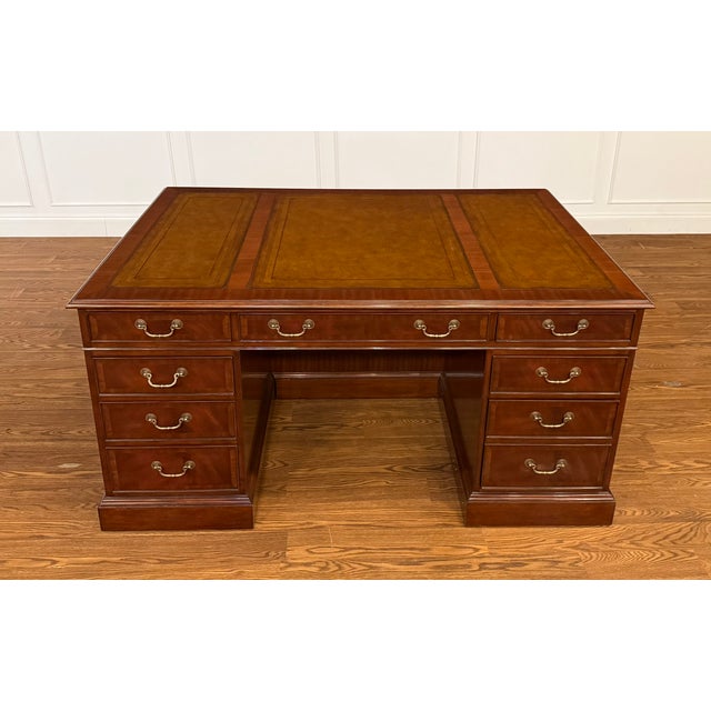 This is a traditional mahogany executive desk by Leighton Hall. It features front, side and drawer panels of swirly crotch...