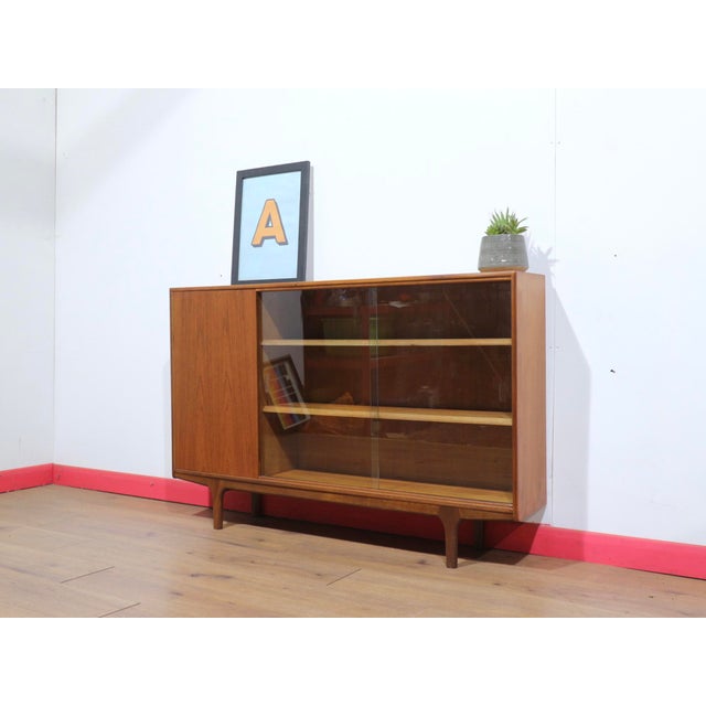 A stylish display cabinet by renowned furniture maker Mcintosh, this Mid Century Modern Vintage British Teak Display China...