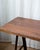 An industrial A-frame standing writing desk featuring a solid wood top paired with bold metal legs. Clean, architectural...