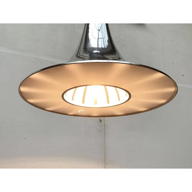 Imposing Space Age pendant lamp from Italy. The luminous body is designed in trumpet shape and extends strongly downwards....
