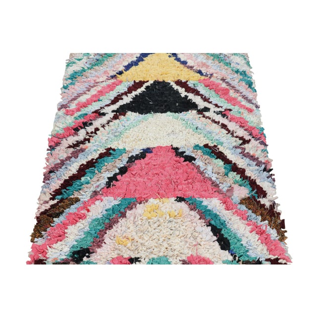 Hand-knotted in wool and originating from Morocco circa 1950-1960, this 3x6 vintage Moroccan rug is an extremely rare...