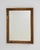 A decorative wall mirror featuring a carved giltwood frame, embodying classic French elegance. The intricate detailing...