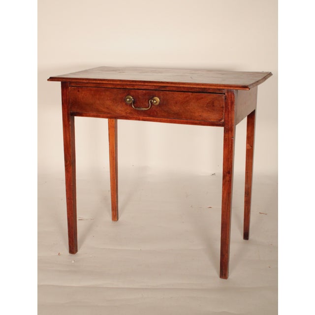 George III mahogany writing table, early 19th century. With a two board top with thumb molded front and side edges, a...