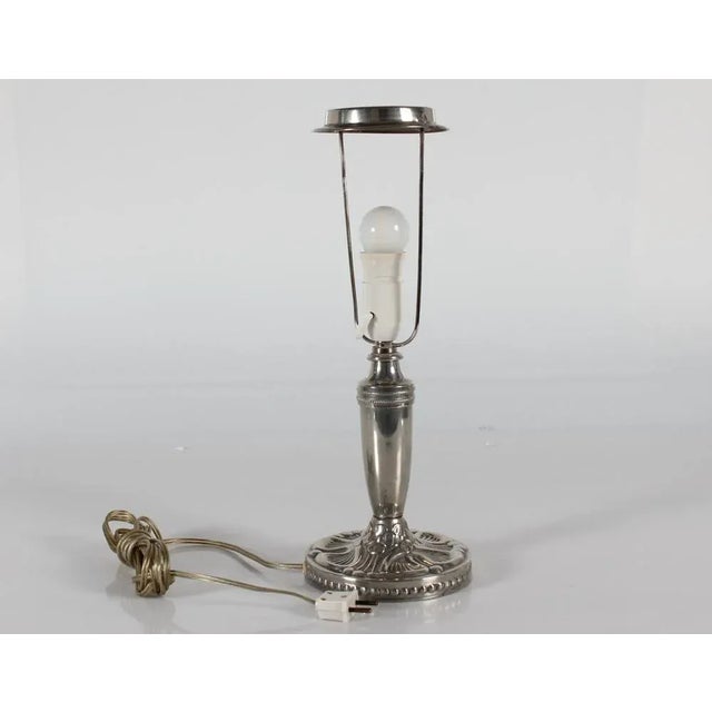Danish Art Nouveau table lamp made of pewter with floral pattern. The lamp is manufactured in Denmark in the period...