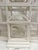 A striking decorative birdcage designed as a miniature architectural pavilion, finished in a soft painted white. Its...