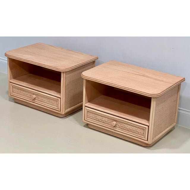 A handsome pair of French oak and woven cane nightstands by Maugrion for Roche Bobois, circa 1980. Each nightstand...