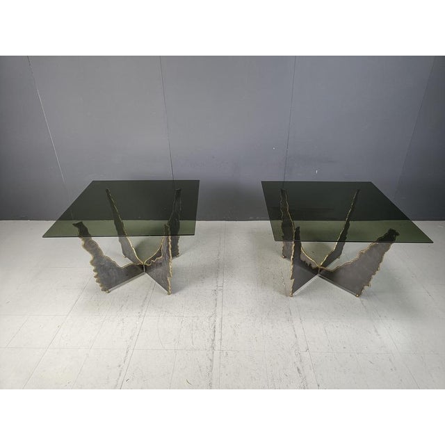 Pair of sculptural cut steel and brass coffee tables or side tables with a smoked glass top. Real pieces of art that will...