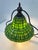 Elegant Tiffany-style table lamp featuring a beautifully crafted green stained glass shade with geometric patterning. The...