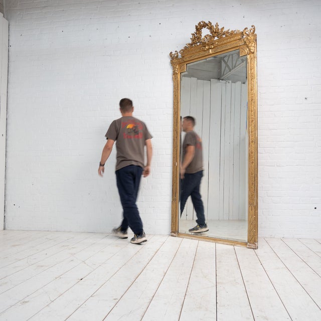 Large pedimented mirror, Napoleon III Gilded with gold leaf. Rich floral decoration and laurel wreath. Beveled mercury...