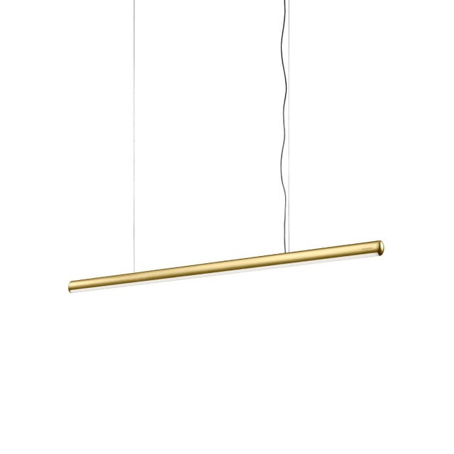 The Tratto suspension lamp features a sleek, linear design in a gold steel finish that balances elegance with subtle...