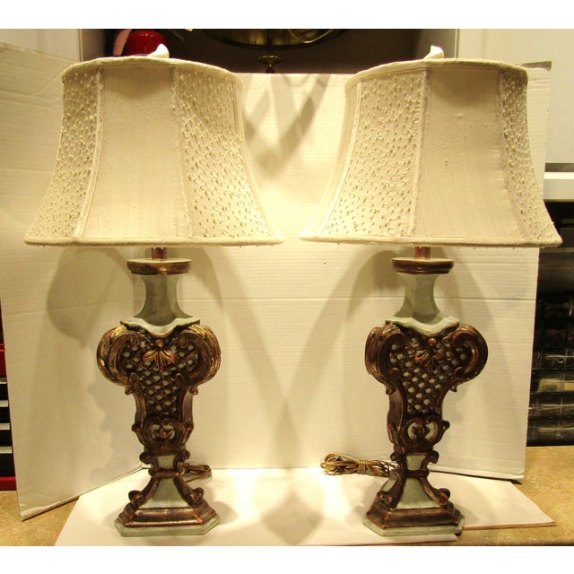 These Italian Baroque style hand-carved wood lamps with silk shades are a unique and elegant addition to any home decor....