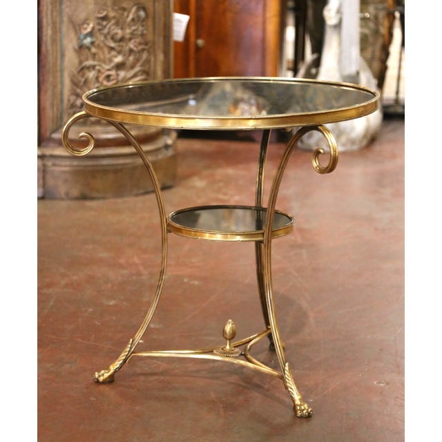 Combining graceful neoclassical lines with finely detailed metalwork, this antique French guéridon table features a...