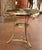 Combining graceful neoclassical lines with finely detailed metalwork, this antique French guéridon table features a...