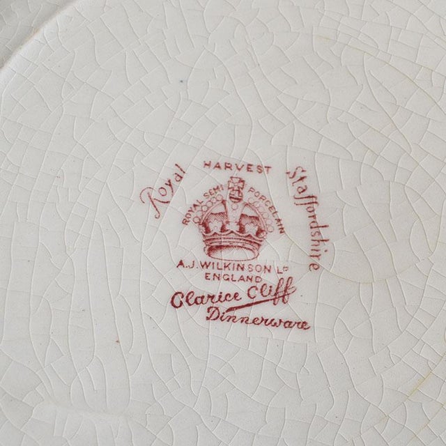 A pretty scalloped dinner plate by Clarice Cliff for Royal Staffordshire. Created from porcelain, this pretty floral motif...