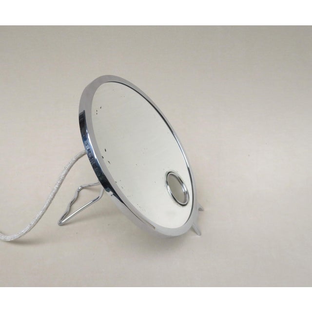 An elegant and rare table mirror, made in france by le mirophar brot. It is illuminated and a magnifying mirror. The stand...