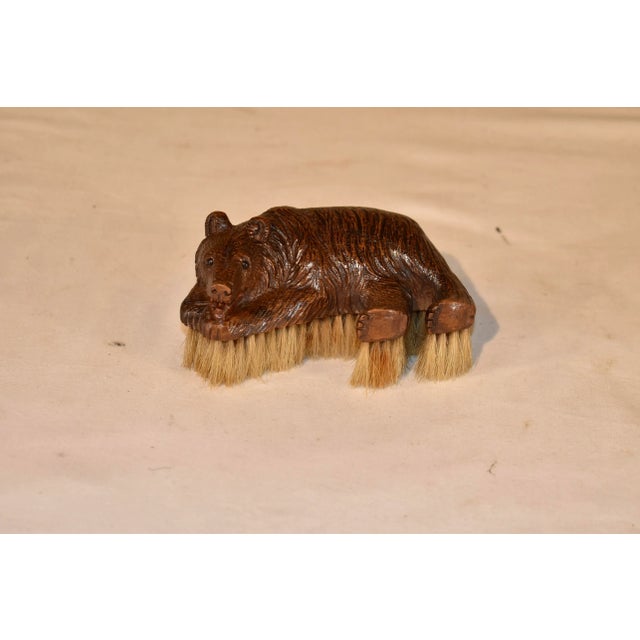 19th century hand carved Black Forest clothes brush in the form of a bear. The bear is recumbent, and his face is so sweet...