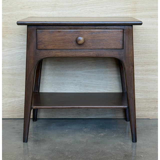 Exquisite pair of Danish teak end tables circa 1960s. These sculptural Mid-Century Modern pieces embody the elegance and...