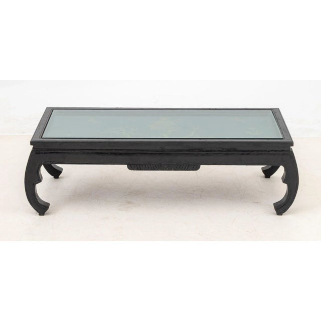 Chinese Ebonized and Paint-Decorated Low Table, 20th century, the rectangular top with inset glass panel, painted with a...