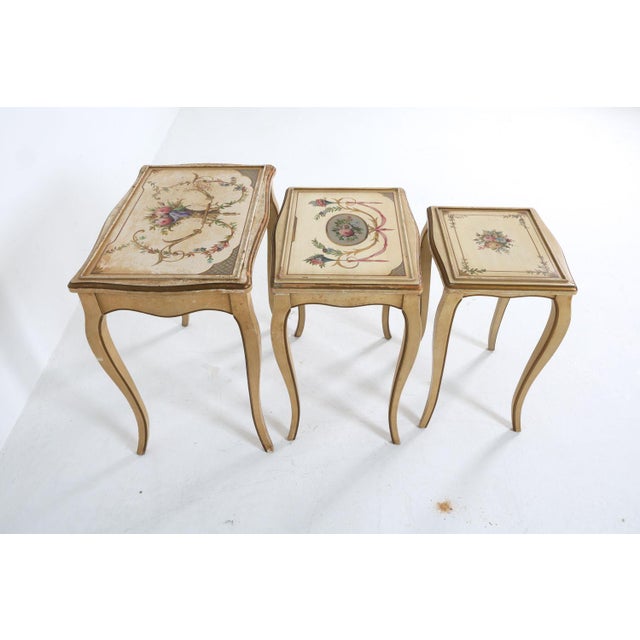 Mid 20th century set of (3) painted nesting tables with carved and painted wood. These are labeled, Kozak Studios, which...