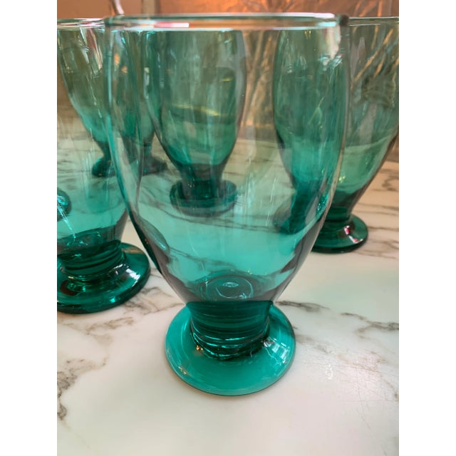 Here we have a set of eight gorgeous teal footed drinking glasses. Each holds 12 oz. to the very rim and 10 ounces...