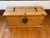 A vintage knotty pine trunk with iron strap hinges and hardware. Lovely at the foot of a bed or as a coffee table....