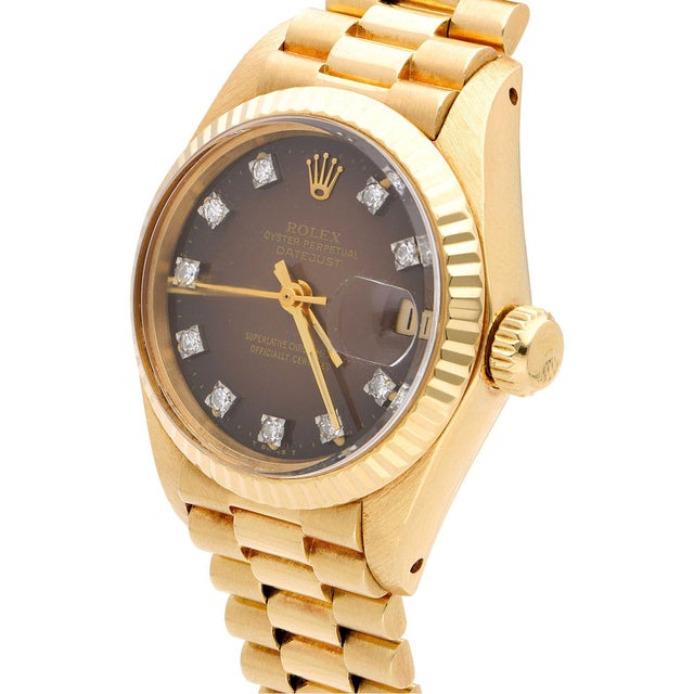Vintage Rolex Datejust reference 6917 features a brown dial with factory-set round diamond hour markers and gold hands...