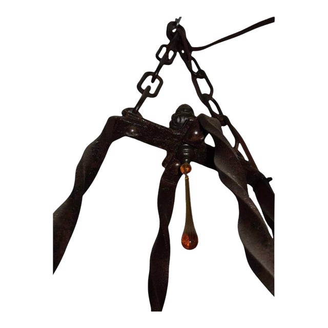 This exquisite chandelier was handcrafted from an antique aquarium stand turned upside down. It features twisted iron...