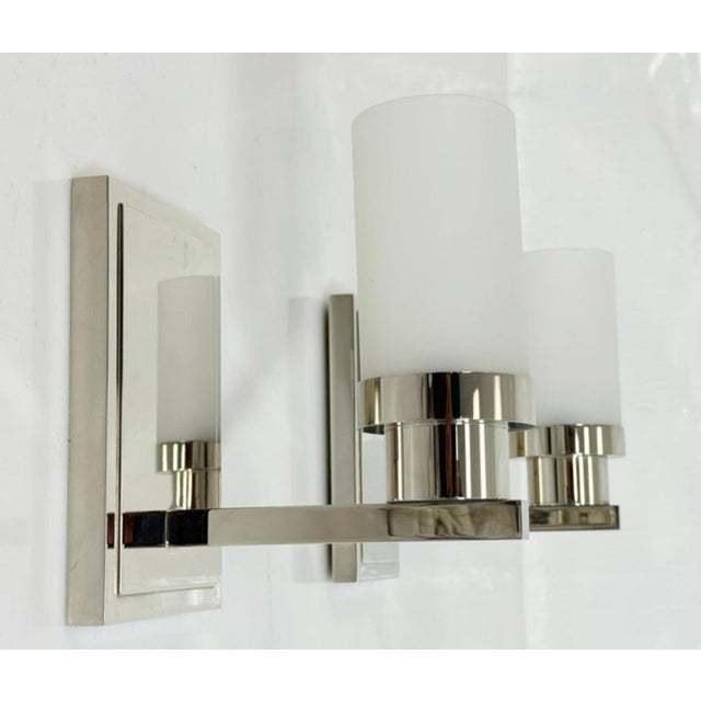 A sophisticated pair of "Six of One" wall sconces designed and manufactured in the United States by Marian Jamieson....