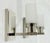 A sophisticated pair of "Six of One" wall sconces designed and manufactured in the United States by Marian Jamieson....