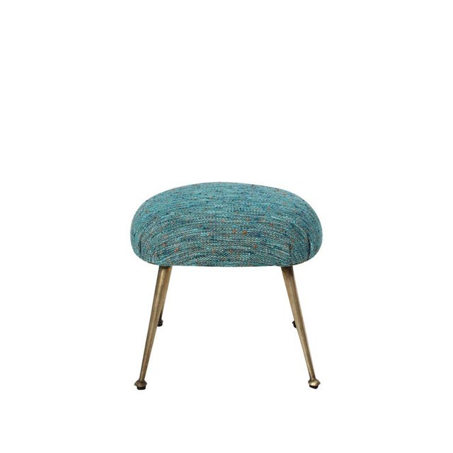 Elegant Italian footstool from the 1950s, featuring an oval form upholstered in blue fabric. The piece is supported by...