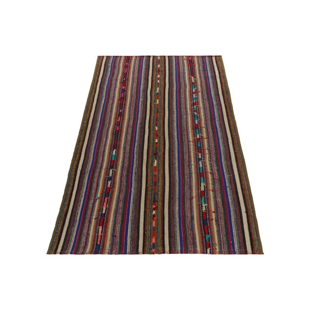 Handwoven in Turkey originating between 1950-1960, this 5'6x7' vintage Chaput style Kilim rug enjoys an appealing...