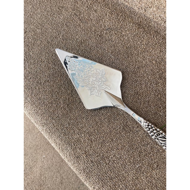 Godinger Silver Art Serving Knife with a motif of leaves.