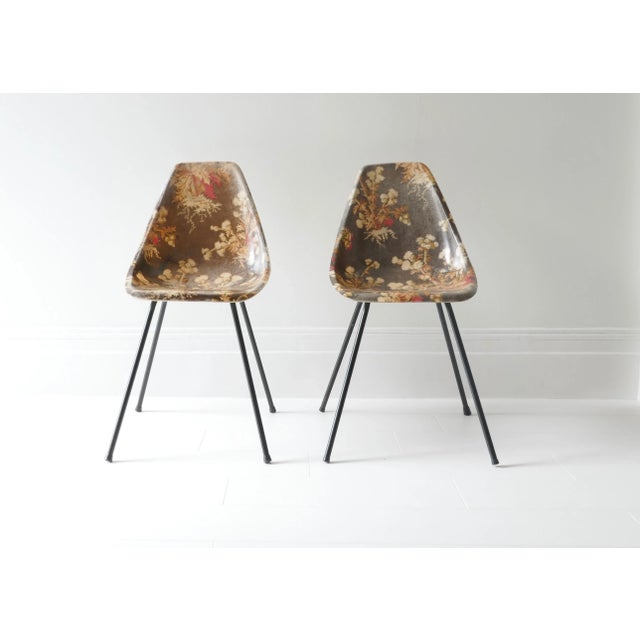 A rare set of 2 fibreglass chairs by Rene Jean Caillette. Brown background and multicolour floral pattern. Designed and...