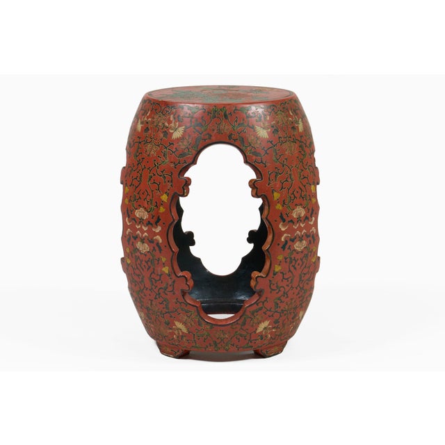 Vintage Chinese red lacquered wooden barrel-shaped garden seat or stool with carved openwork side panels, decorated with...