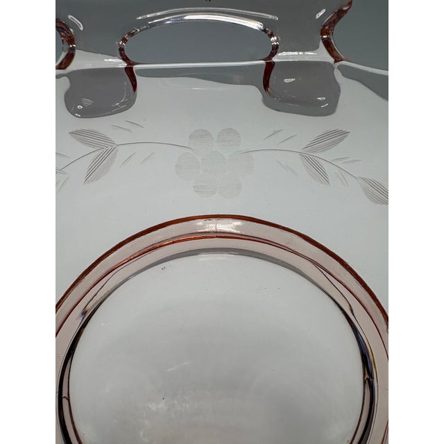 A refined American Elegant Glass handled serving dish in soft blush pink, crafted in the late Depression to early post-...