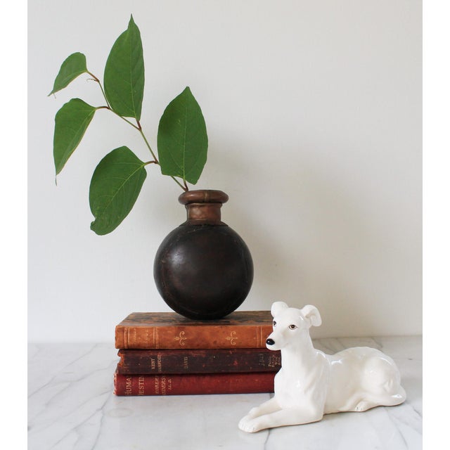 Vintage hand forged iron and copper oil or water storage vessel. Does hold water, however if you fill it up to the top...