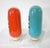 A pair of handblown inverted glass pharmaceutical advertising display bottles one in blue with Copric Chloride and in...