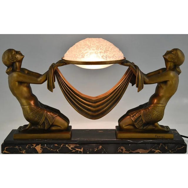 Offrande Art Deco table lamp with kneeling nudes holding a Daum glass shade signed Fayral, pseudonym of Pierre Le Faguays...