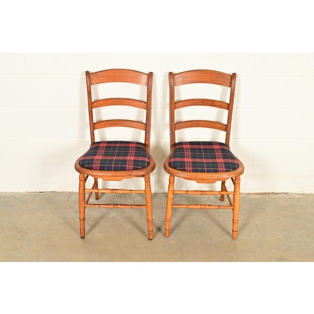 A beautiful pair of antique English Regency ladder back side chairs or dining chairs England, Circa 1890s Carved solid...